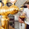 Beer being poured from bar taps